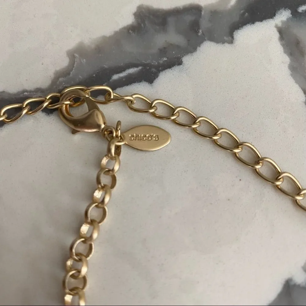 Chico’s long Kira gold tone charm necklace